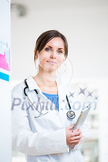 Pretty, female doctor in a hospital lab (image with copy space; color toned) Pretty, female doctor in a hospital lab (image with copy space; color toned)