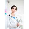 Pretty, female doctor in a hospital lab (image with copy space; color toned)