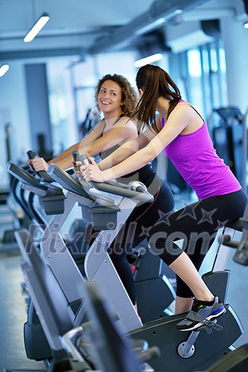 group of young people running on treadmills in modern sport  gym