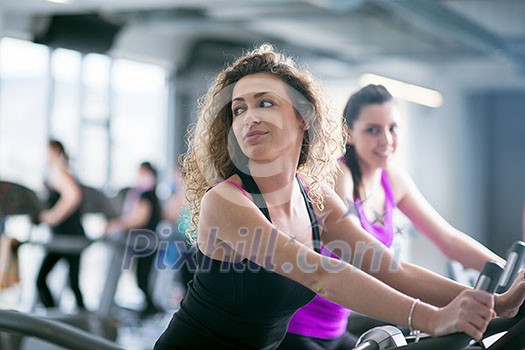 group of young people running on treadmills in modern sport gym group of young people running on treadmills in modern sport gym