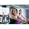 group of young people running on treadmills in modern sport  gym