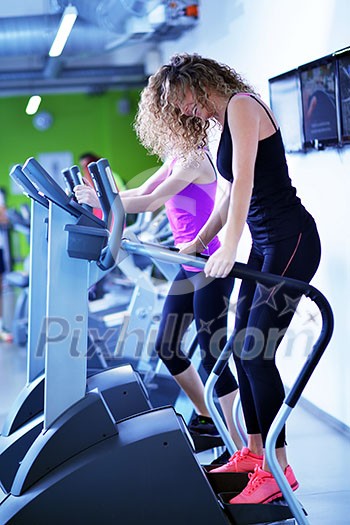 group of young people running on treadmills in modern sport gym group of young people running on treadmills in modern sport gym