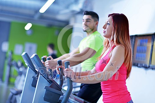 group of young people running on treadmills in modern sport gym group of young people running on treadmills in modern sport gym