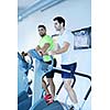 group of young people running on treadmills in modern sport  gym