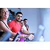 group of young people running on treadmills in modern sport  gym