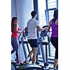 sport, fitness, lifestyle, technology and people concept - smiling woman exercising on treadmill in gym