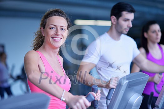 group of young people running on treadmills in modern sport gym group of young people running on treadmills in modern sport gym