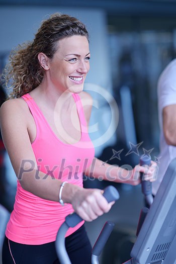 sport, fitness, lifestyle, technology and people concept - smiling woman exercising on treadmill in gym