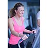 sport, fitness, lifestyle, technology and people concept - smiling woman exercising on treadmill in gym