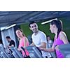 group of young people running on treadmills in modern sport  gym