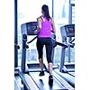 sport, fitness, lifestyle, technology and people concept - smiling woman exercising on treadmill in gym