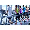 group of young people running on treadmills in modern sport  gym