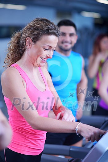sport, fitness, lifestyle, technology and people concept - smiling woman exercising on treadmill in gym sport, fitness, lifestyle, technology and people concept - smiling woman exercising on treadmill in gym