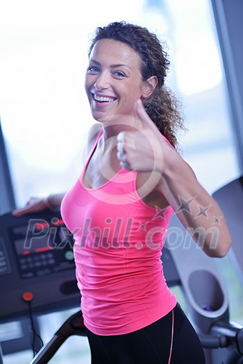 sport, fitness, lifestyle, technology and people concept - smiling woman exercising on treadmill in gym