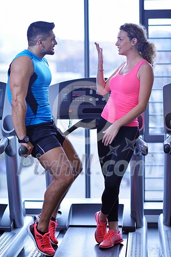 attractive couple at the gym looking happy attractive couple at the gym looking happy