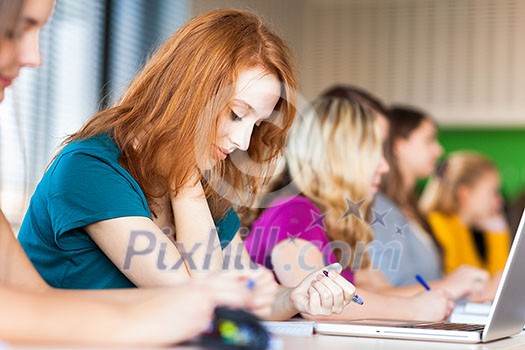Students in a classroom during class (color toned image; shallow DOF)