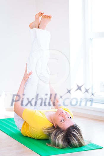Pretty young woman doing YOGA exercise at home Pretty young woman doing YOGA exercise at home