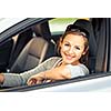 Pretty young woman driving her new car  (color toned image; shallow DOF)