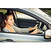 Pretty young woman driving her new car  (color toned image; shallow DOF)