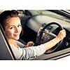 Pretty young woman driving her new car  (color toned image; shallow DOF)