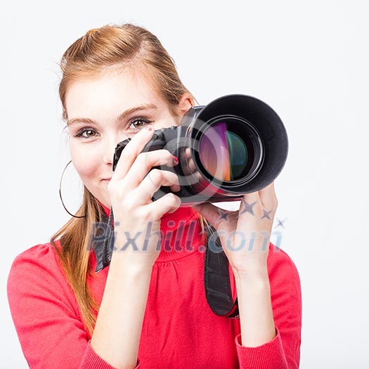 Pretty, female photographer with her digital camera (color toned image; shallow DOF) Pretty, female photographer with her digital camera (color toned image; shallow DOF)