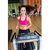 sport, fitness, lifestyle, technology and people concept - smiling woman exercising on treadmill in gym