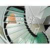 modern glass spiral staircase with metallic hand-rails.