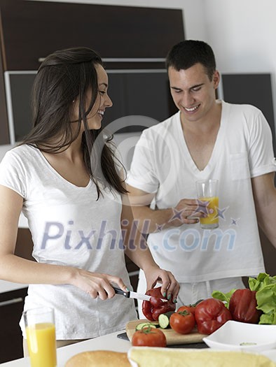 happy young couple have fun in modern kitchen indoor while preparing fresh fruits and vegetables food salad happy young couple have fun in modern kitchen indoor while preparing fresh fruits and vegetables food salad