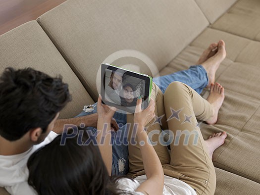 cheerful happy young couple making selfie together at home