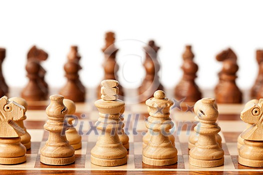 Wooden chess pieces on chessboard. Selective focus, shallow depth of field