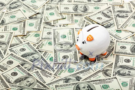 Piggy bank on dollars background Piggy bank on dollars background