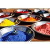 India symbol. Colored colorful powder kumkum in bowls on Indian bazaar for Holi and other festivals celebration