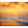 Ocean sunrise on beach defocused background