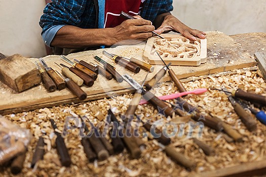Carver in wood working in workshop, India Carver in wood working in workshop, India