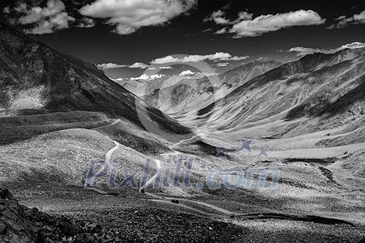 Himalayan valley landscape with road near Kunzum La pass - allegedly the highest motorable pass in the world 5602 m, Ladakh, India. Black and white version