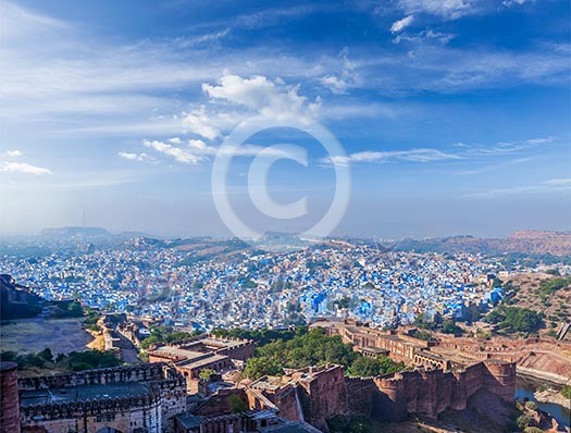 Aerial panorama of Jodhpur, also known as Blue City due to the vivid blue-painted Brahmin houses. View from Mehrangarh Fort part of fortifications is also visible. Jodphur, Rajasthan, India Aerial panorama of Jodhpur, also known as Blue City due to the vivid blue-painted Brahmin houses. View from Mehrangarh Fort part of fortifications is also visible. Jodphur, Rajasthan, India