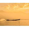 Speeding motor boat silhouette on Inle lake on sunset, Myanmar