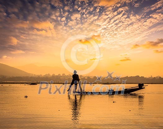 Myanmar travel attraction landmark - traditional Burmese fisherman sihouettes at Inle lake on sunset, Myanmar famous for their distinctive one legged rowing style Myanmar travel attraction landmark - traditional Burmese fisherman sihouettes at Inle lake on sunset, Myanmar famous for their distinctive one legged rowing style