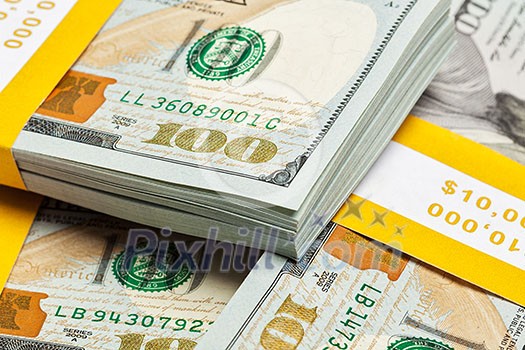 Creative business finance making money concept - background of of new 100 US dollars 2013 edition banknotes bills bundles close up
