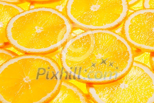 Colorful orange citrus fruit slices background backlit Colorful orange citrus fruit slices background backlit
