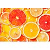 Colorful citrus fruit - lemon, orange, grapefruit - slices background. Backlit