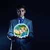 Young businessman holding Earth planet in palm. Elements of this image are furnished by NASA