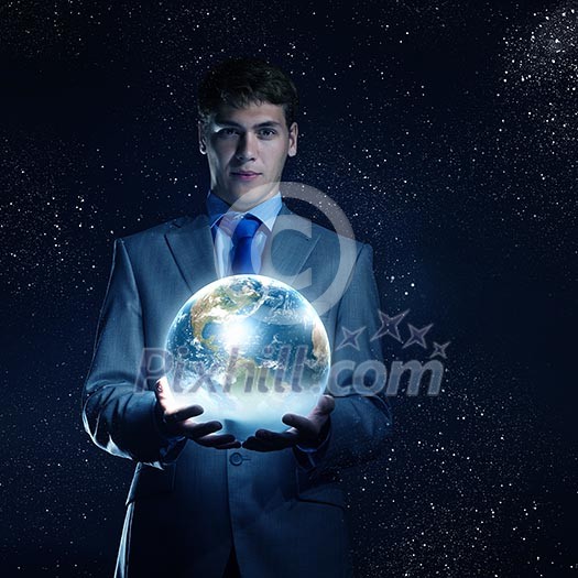 Young businessman holding Earth planet in palm. Elements of this image are furnished by NASA