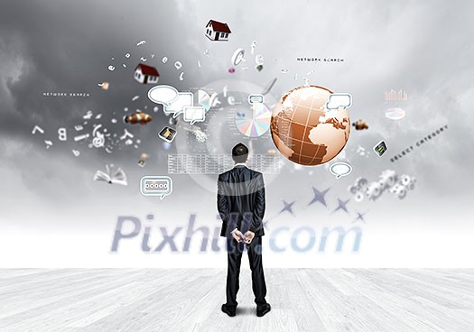 Back view of confident businessman looking at items flying in air Back view of confident businessman looking at items flying in air