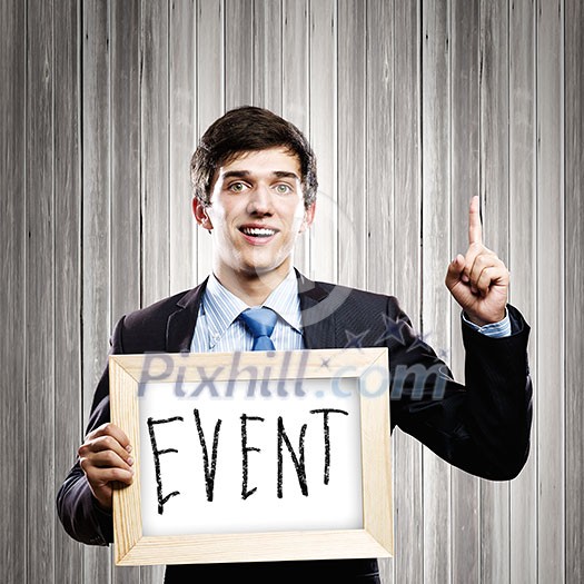 Handsome businessman holding wooden frame with words Handsome businessman holding wooden frame with words