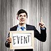 Handsome businessman holding wooden frame with words