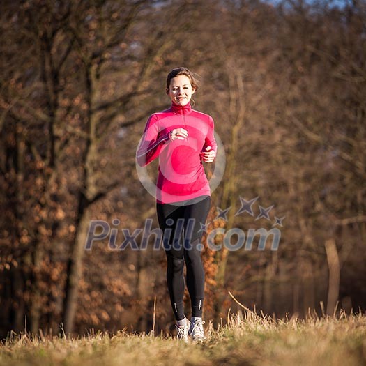 Young woman running outdoors on a lovely sunny winter/fall day Young woman running outdoors on a lovely sunny winter/fall day