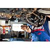 Inside a garage - changing wheels/tires (shallow DOF; color toned image)