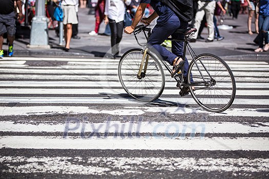 Man on a bike on a crossing in Manhattan, NYC