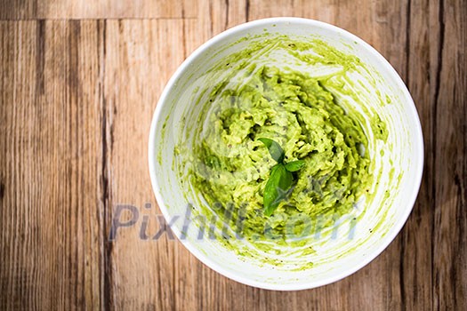 Fresh avocado guacamole on rice bred with basil